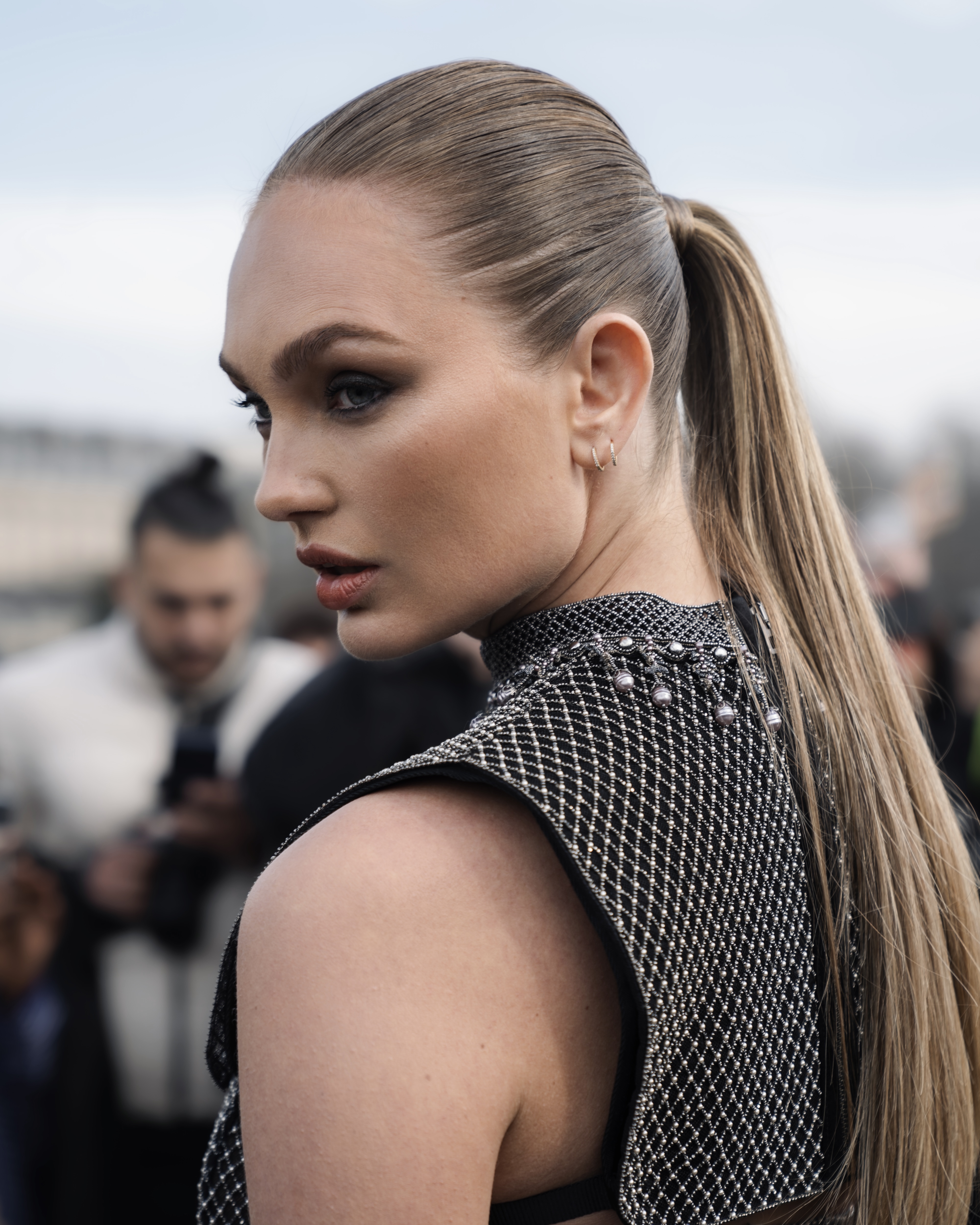 Side profile of model with ponytail in textured top